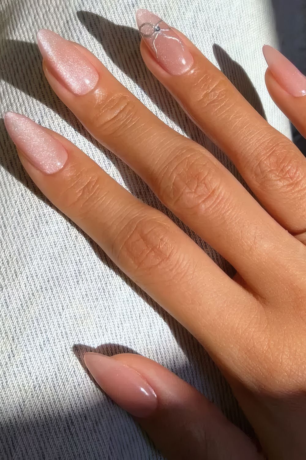 Long Almond Pink Glitter Chrome Nails with Silver Bow Detail