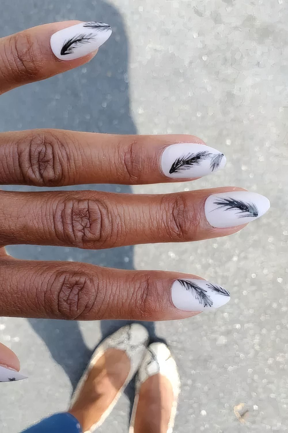 Matte white nails with black feather designs